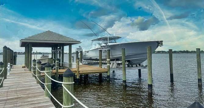 Custom boat lift with sportfishing boat at residential dock in Port St. Lucie, FL
